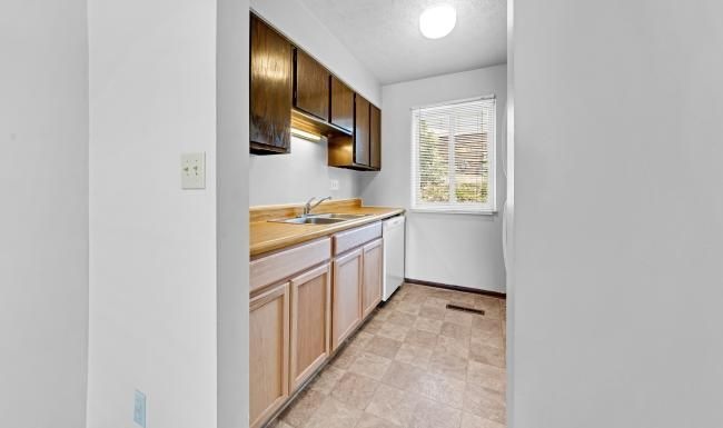a kitchen with wooden cabinets