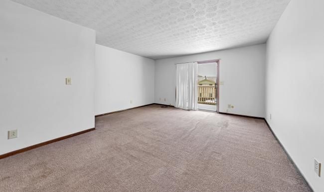 a spacious carpeted living room