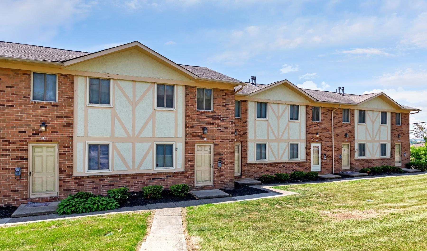 a brick building with a sidewalk